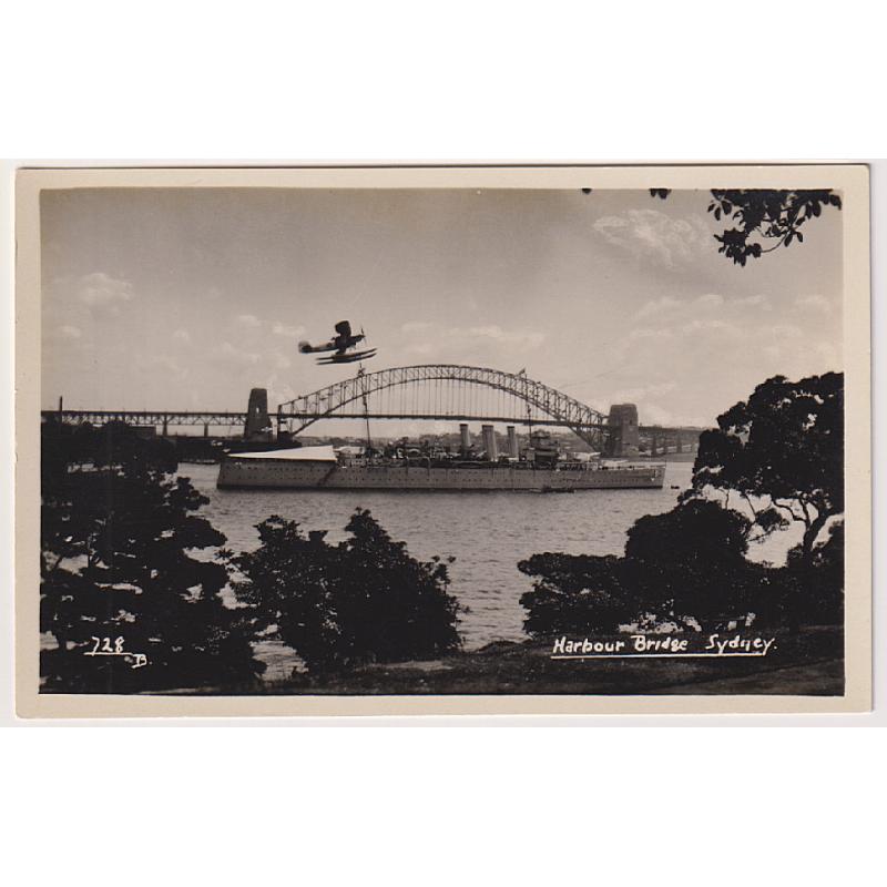 (CR1011) NEW SOUTH WALES · 1930s: unused real photo card (publisher not identified) w/view HARBOUR BRIDGE SYDNEY featuring a warship and a naval seaplane · VF condition