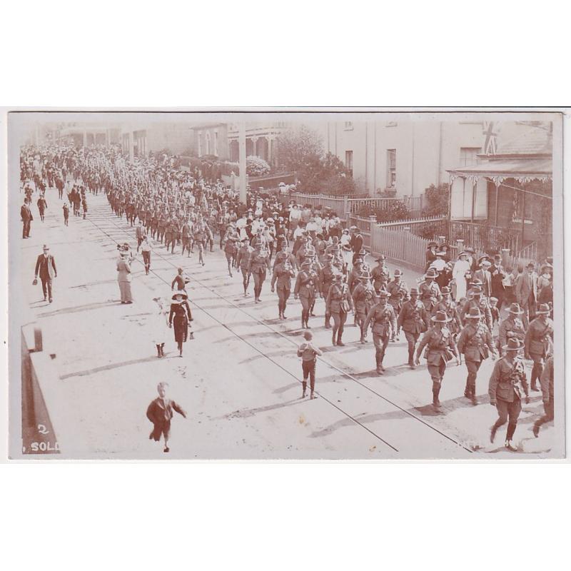 (FE1046) TASMANIA · c.1914: unused real photo card by W.J. Little with a view of a MILITARY PARADE in Liverpool Street Hobart near the intersection with Park Street · fine condition