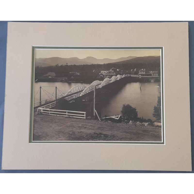 (FE1049A) TASMANIA · large photograph of the first bridge built across the Huon River in 1876 · this print probably dates from the early 1900s however the buildings on the far bank indicate that the negative would date from the 1870s