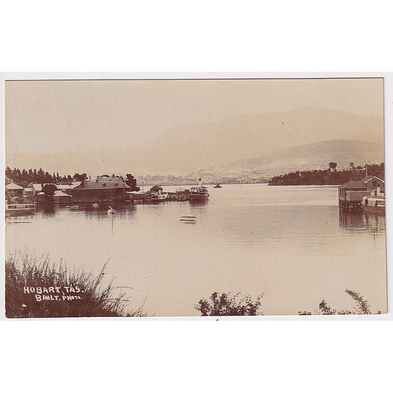 (ME1002) TASMANIA · c.1920: unused real photo card by H.H. Baily with a view of KANGAROO BAY at Bellerive · Sorell Railway jetty on RH side · Hobart visible across the Derwent · fine condition